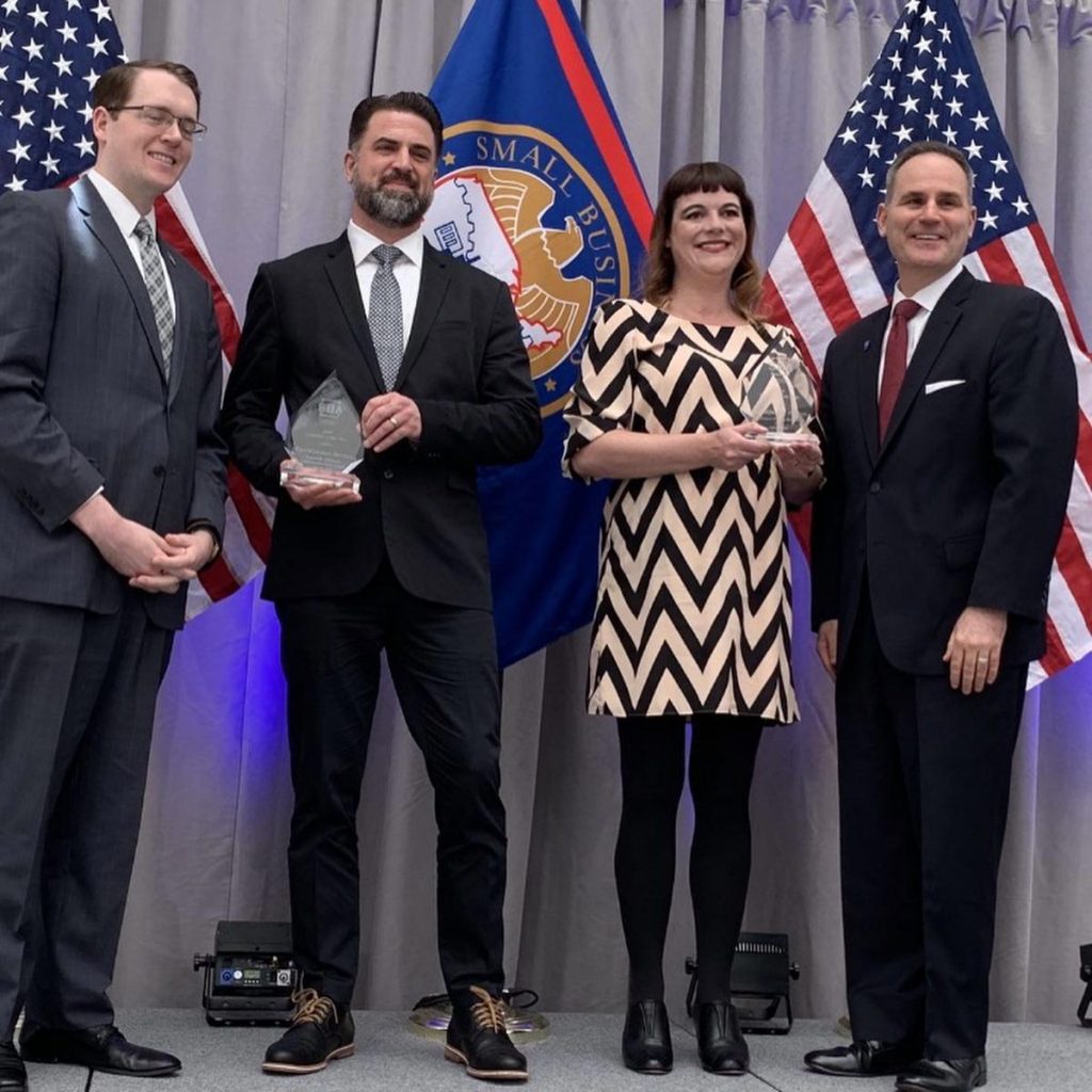 Photo: Akron, Ohio-based EarthQuaker Devices received Exporter of the Year 2019 honors from the U.S. Small Business Administration during a ceremony at the National Institute of Peace on May 6, 2019 (pictured left to right, Associate Administrator of the U.S. Office of International Trade David Glaccum, EarthQuaker Devices President Jamie Stillman, EarthQuaker Devices Chief Executive Officer Julie Robbins, and U.S. Small Business Administration Administrator (Acting) Chris Pilkerton.)