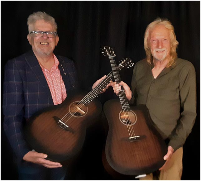 Paul Brett (R) presents Tim Sturges (L) with a. pair of Vintage Statesboro' guitars. V880WK Parlour size acoustic £125rrp and VE440WK Cutaway E/A Dreadnought £179 rrp